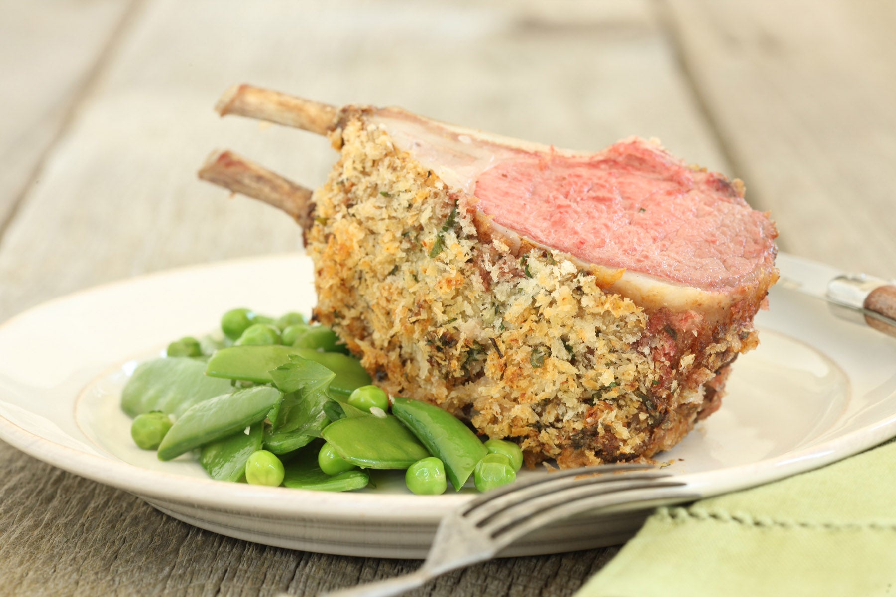 Crispy Herbed Rack of American Lamb with Buttered Spring Pea Mix